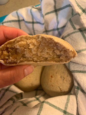 hand holding pao de quiejo showing inner structure