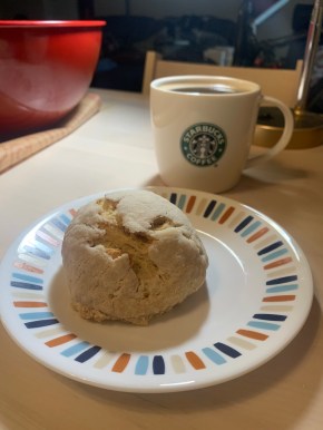 semita de yema on a plate next to a cup of coffee