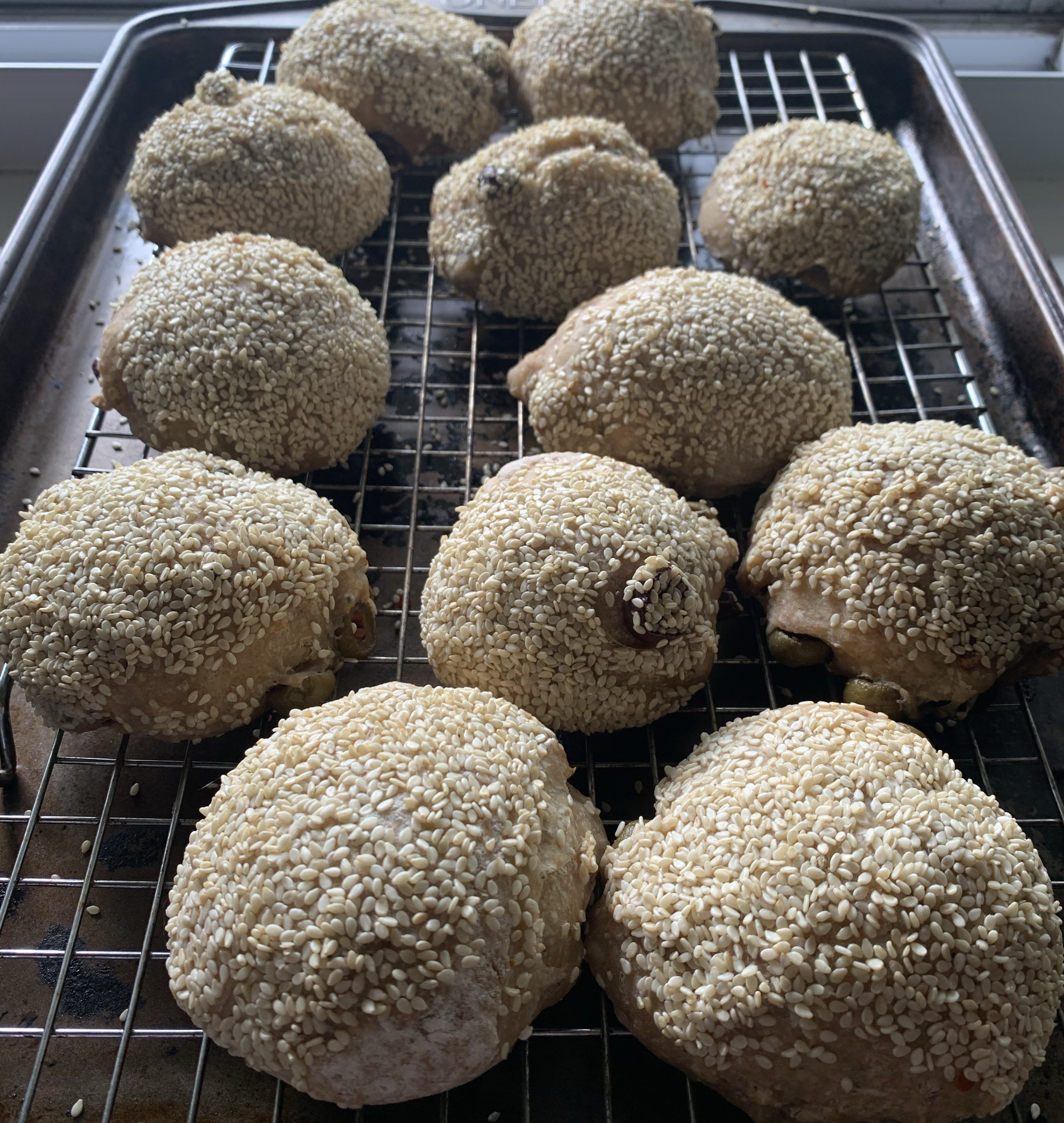 Muffaletta rolls on a cooling rack