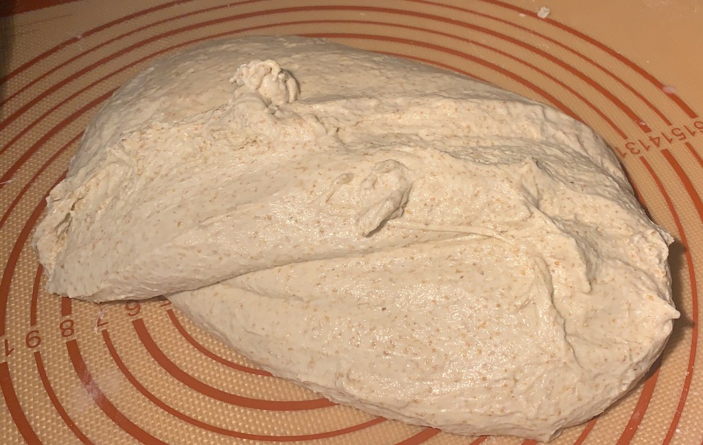 Lump of dough on a rubber mat.