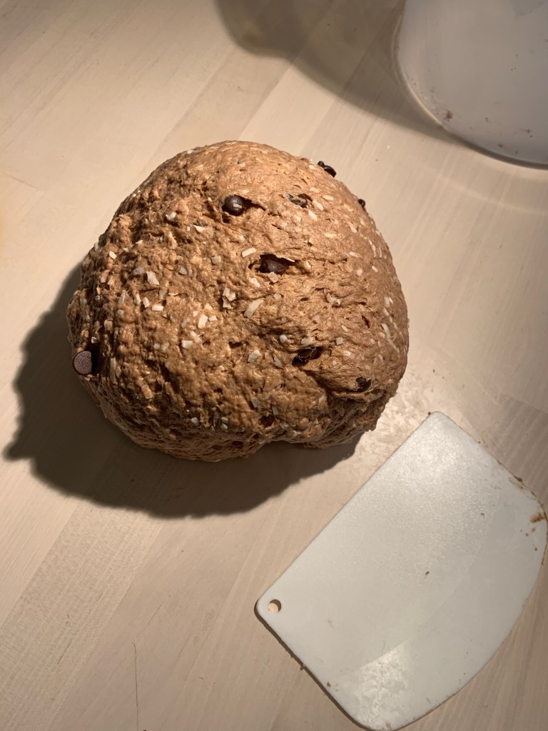 Ball of kneaded dough on table next to dough card