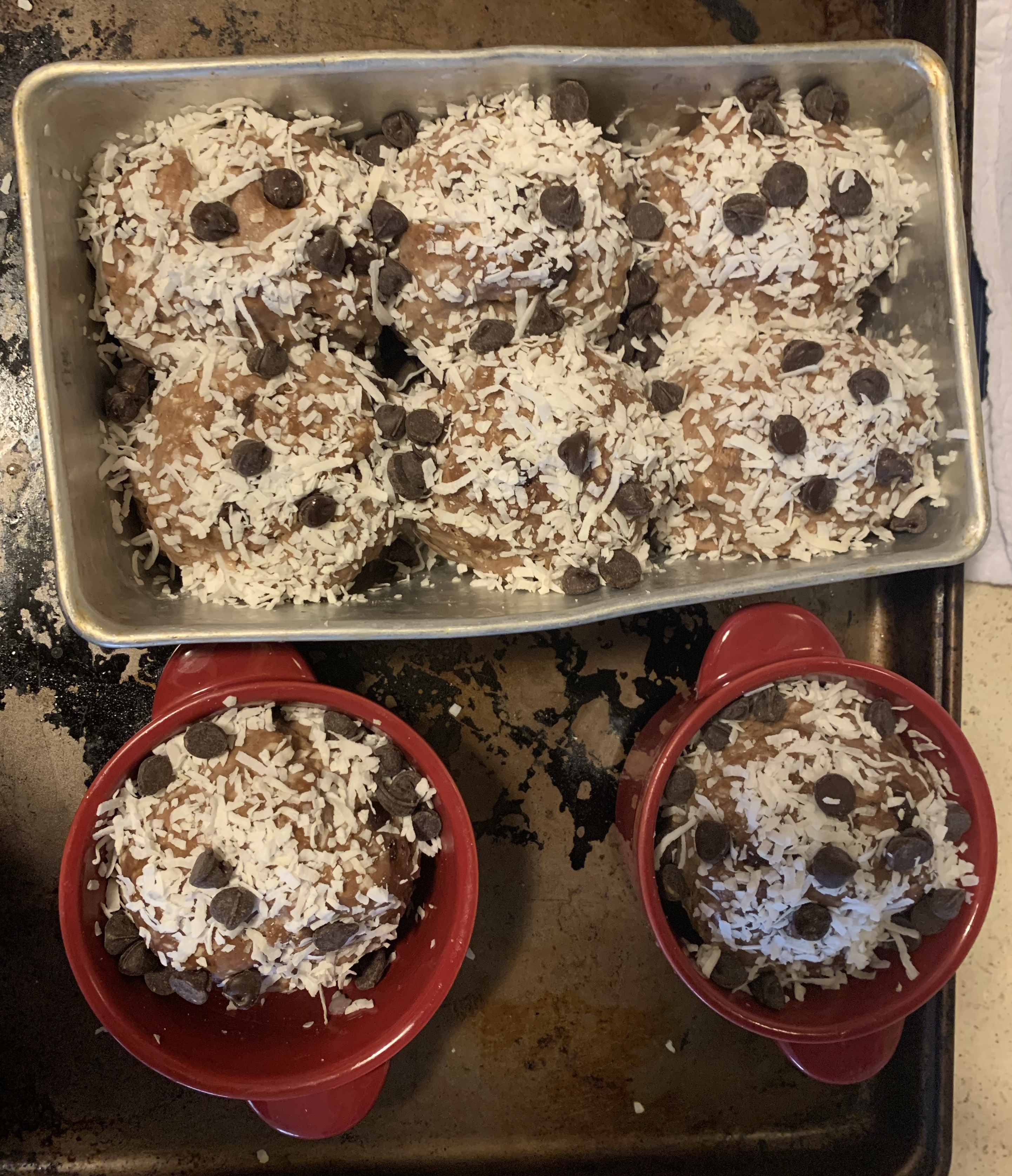 choco pan de coco covered in shredded coconut and chocolate chips, before baking