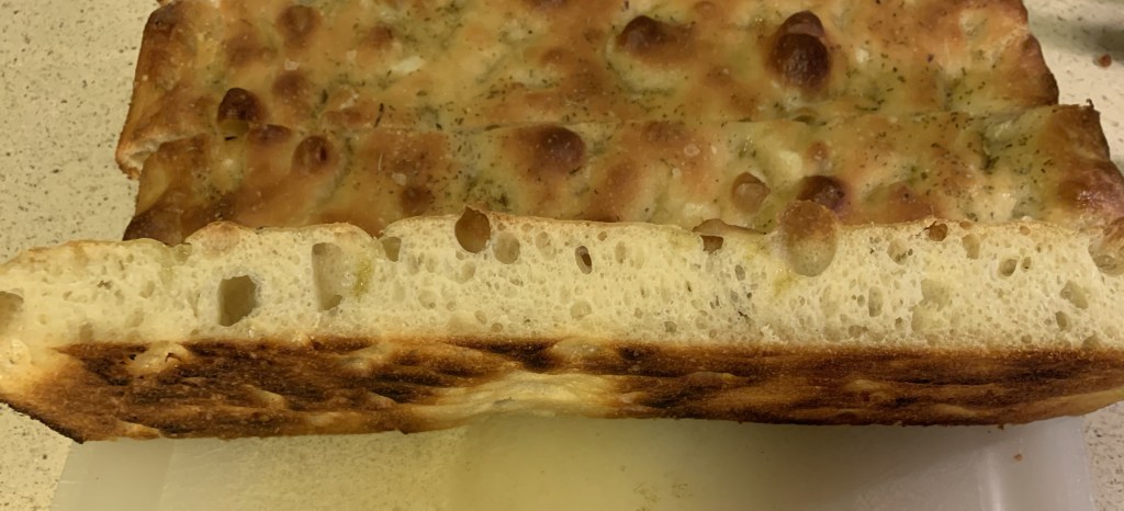 sliced focaccia showing bubbly crumb